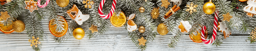 A Christmas garland that has been decorated in golden decorations and dried fruit such as orange slices.