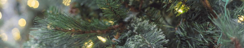 A close up photo of a realistic looking Christmas tree that has pre lit lights attached.